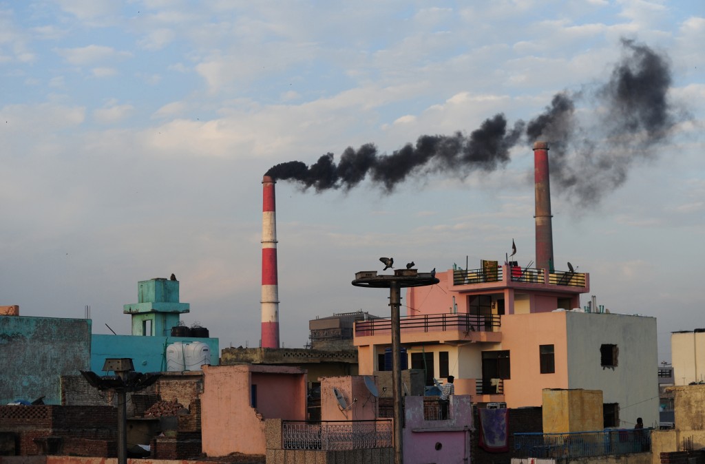 In this photograph taken on March 20, 2015, smoke rises from the Badarpur Thermal Power Station in New Delhi. India, the world's third biggest carbon-emitting country, said October 2 it was "confident" it could cut its emissions intensity by 35 percent by 2030 in the run-up to a key conference in Paris later this year. AFP PHOTO